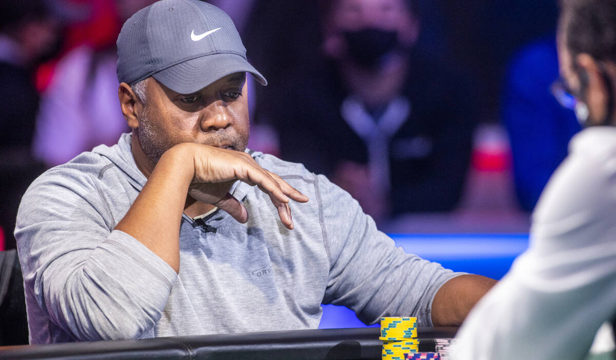 George Holmes considers his hand with three remaining at the final table for the $10,000 buy-in ...
