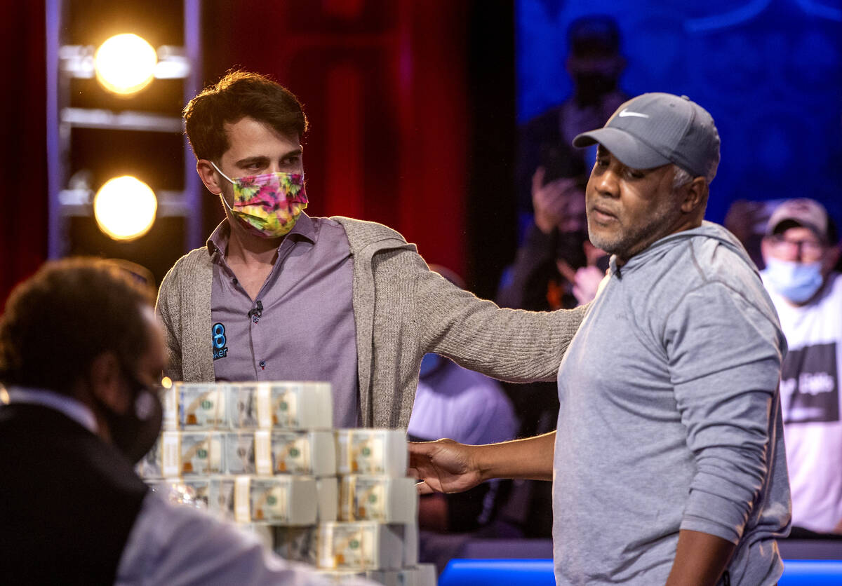 Winner Koray Aldemir shakes hands with his opponent George Holmes on the final table for the $1 ...