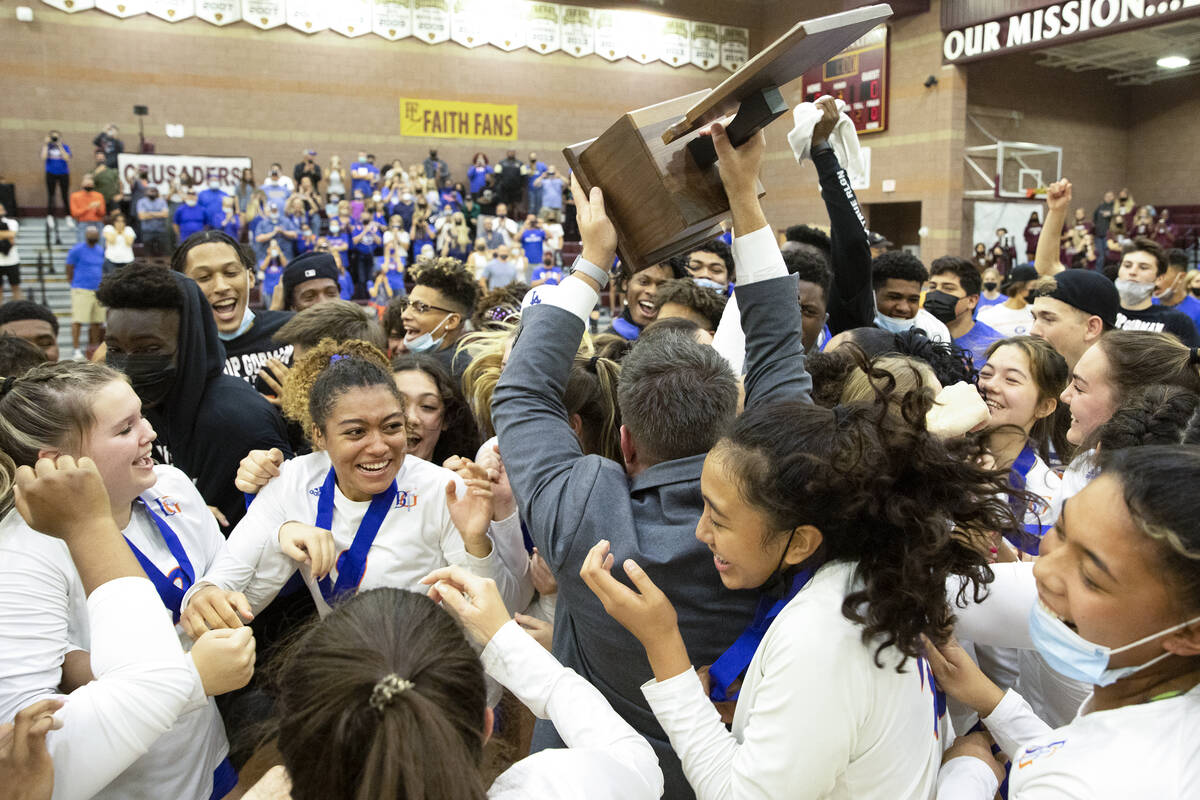 Bishop Gorman head coach Gregg Nunley holds up their first place trophy as the team and fans ra ...