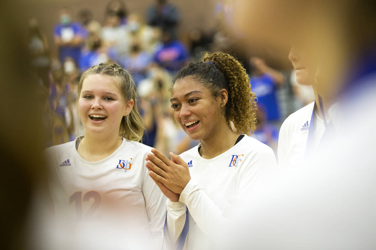 Bishop Gorman's Kendall Allgower, left, and Imani Dambreville cheer for teammates as they accep ...