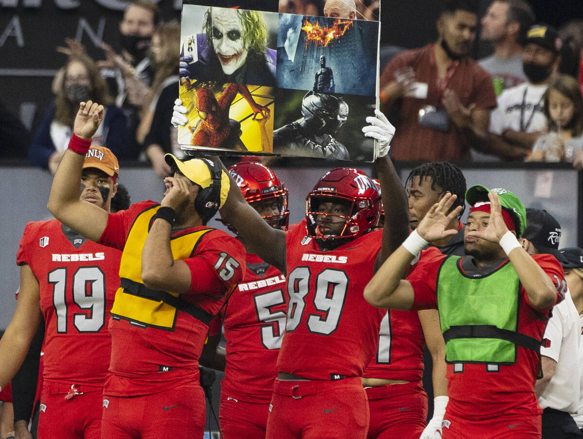 UNLV Rebels players display game signs from the sideline during the second half of an NCAA foot ...