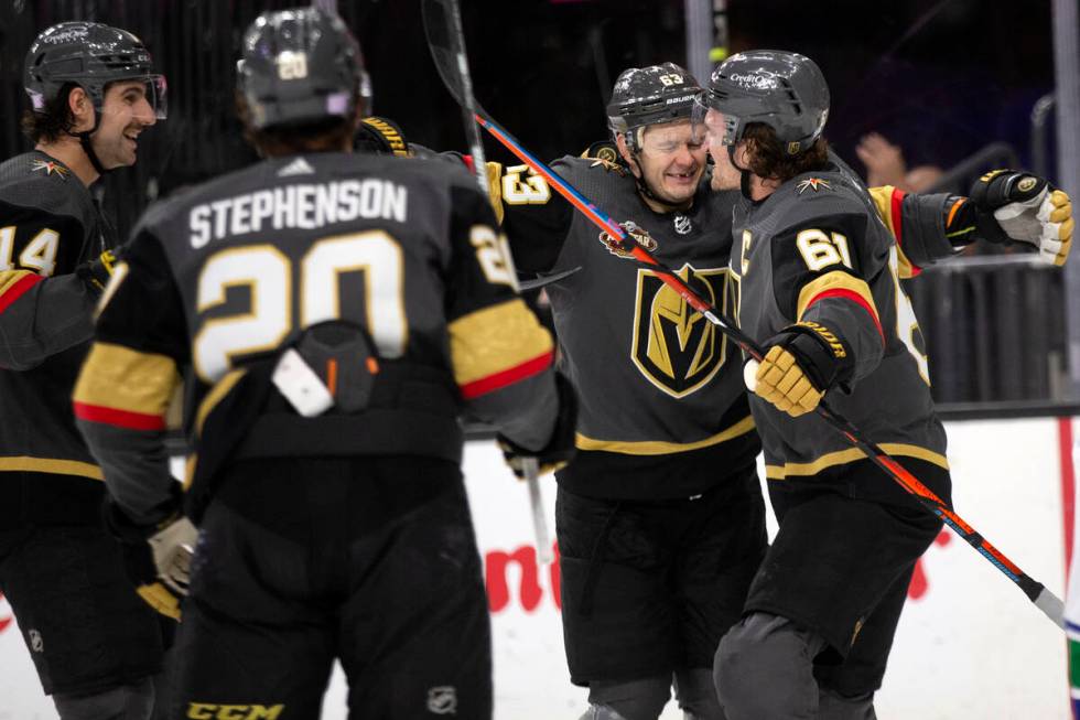 Golden Knights right wing Evgenii Dadonov (63) and right wing Mark Stone (61) celebrate a goal ...