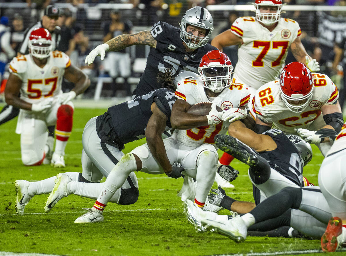 Kansas City Chiefs running back Darrel Williams (31) is tackled by Raiders inside linebacker Co ...