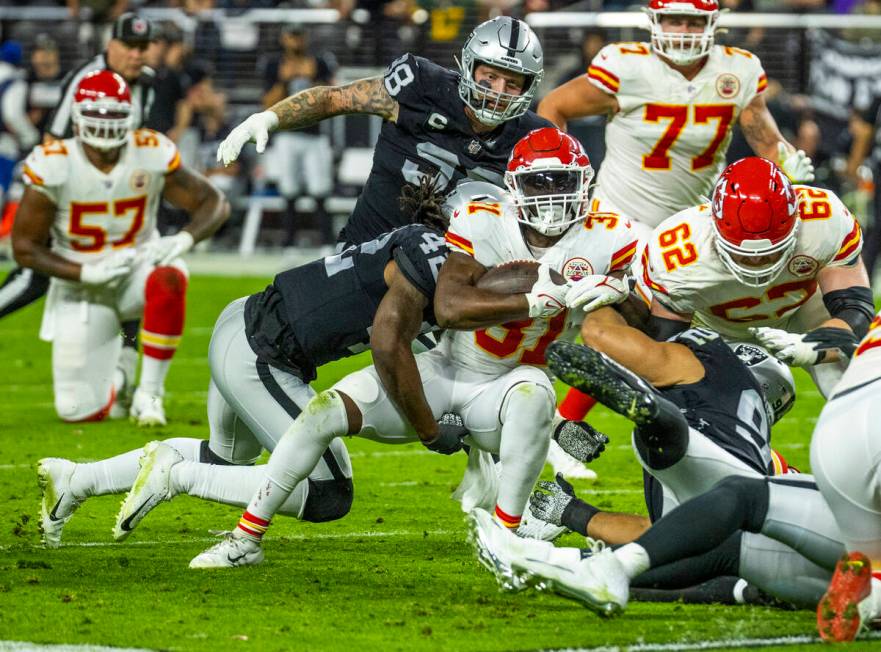 Kansas City Chiefs running back Darrel Williams (31) is tackled by Raiders inside linebacker Co ...