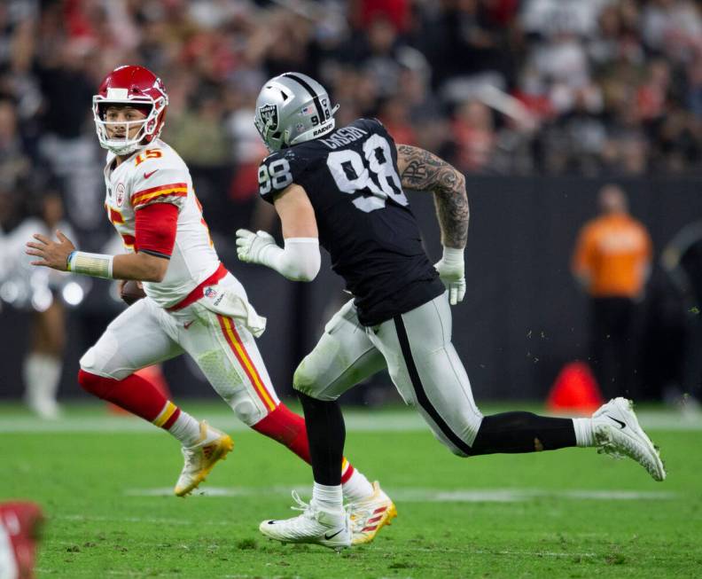 Kansas City Chiefs quarterback Patrick Mahomes (15) tries to escape pressure from Raiders defen ...