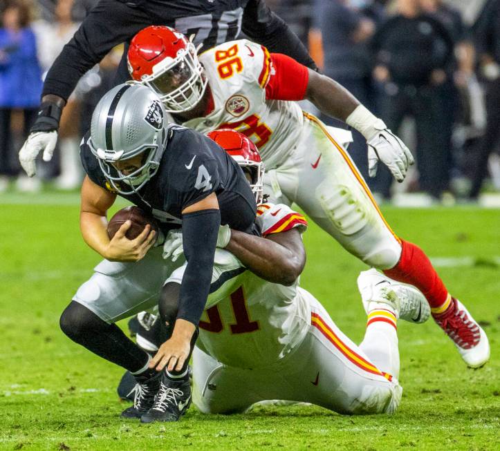 Raiders quarterback Derek Carr (4) is sacked by Kansas City Chiefs defensive tackle Derrick Nna ...