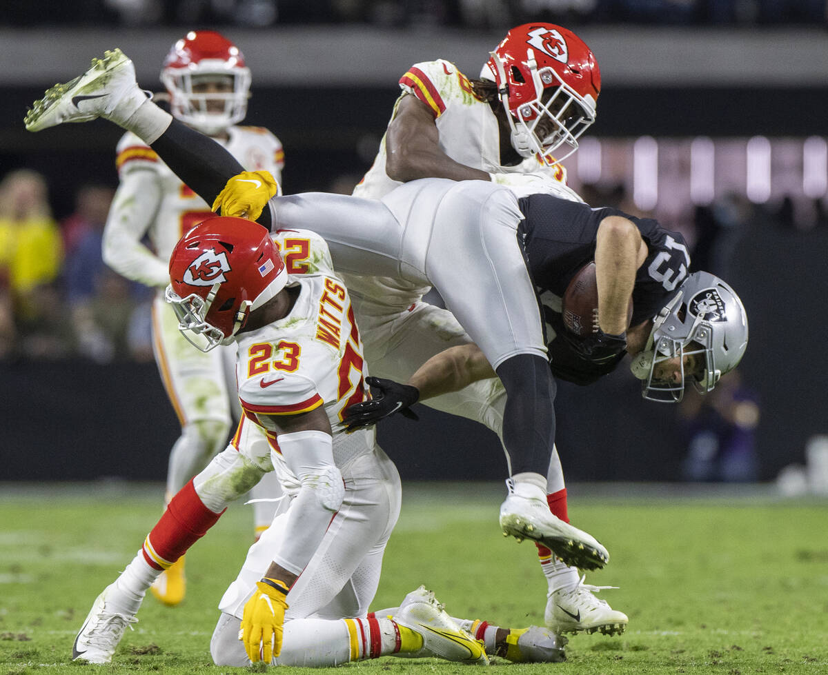 Raiders wide receiver Hunter Renfrow (13) is up ended by Kansas City Chiefs defensive back Arma ...