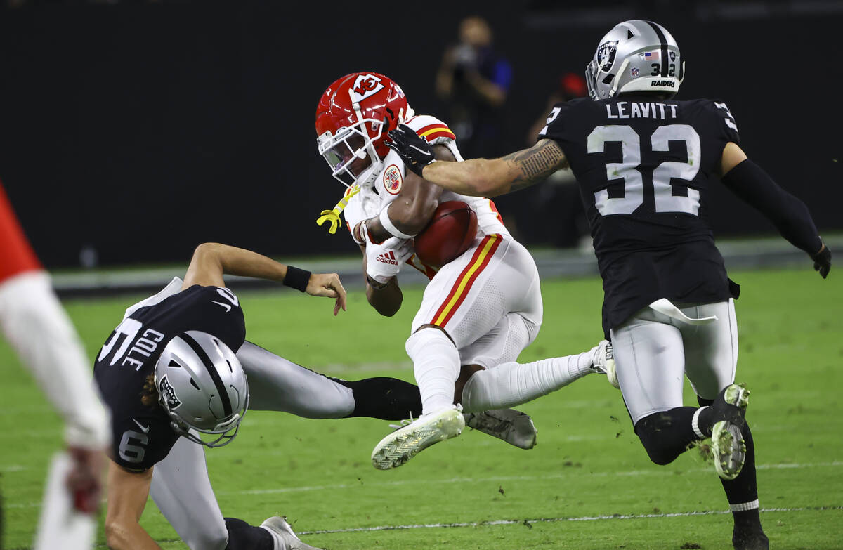 Kansas City Chiefs cornerback Mike Hughes (21) fumbles the ball between Raiders punter A.J. Col ...