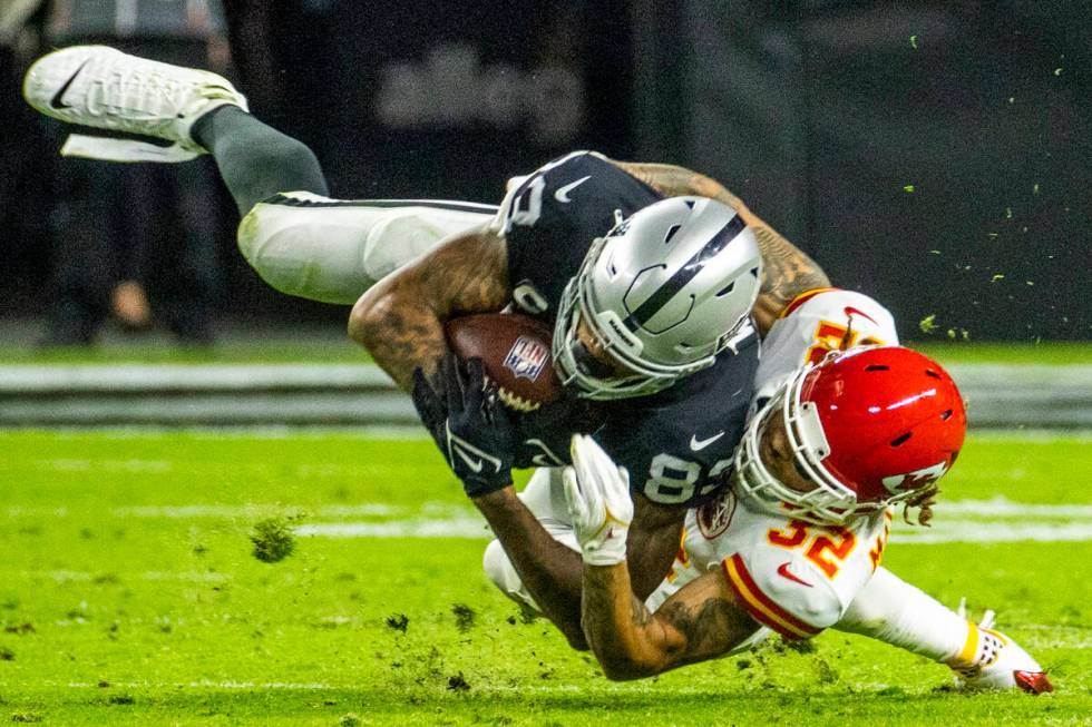 Raiders tight end Darren Waller (83) is tackled by Kansas City Chiefs free safety Tyrann Mathie ...