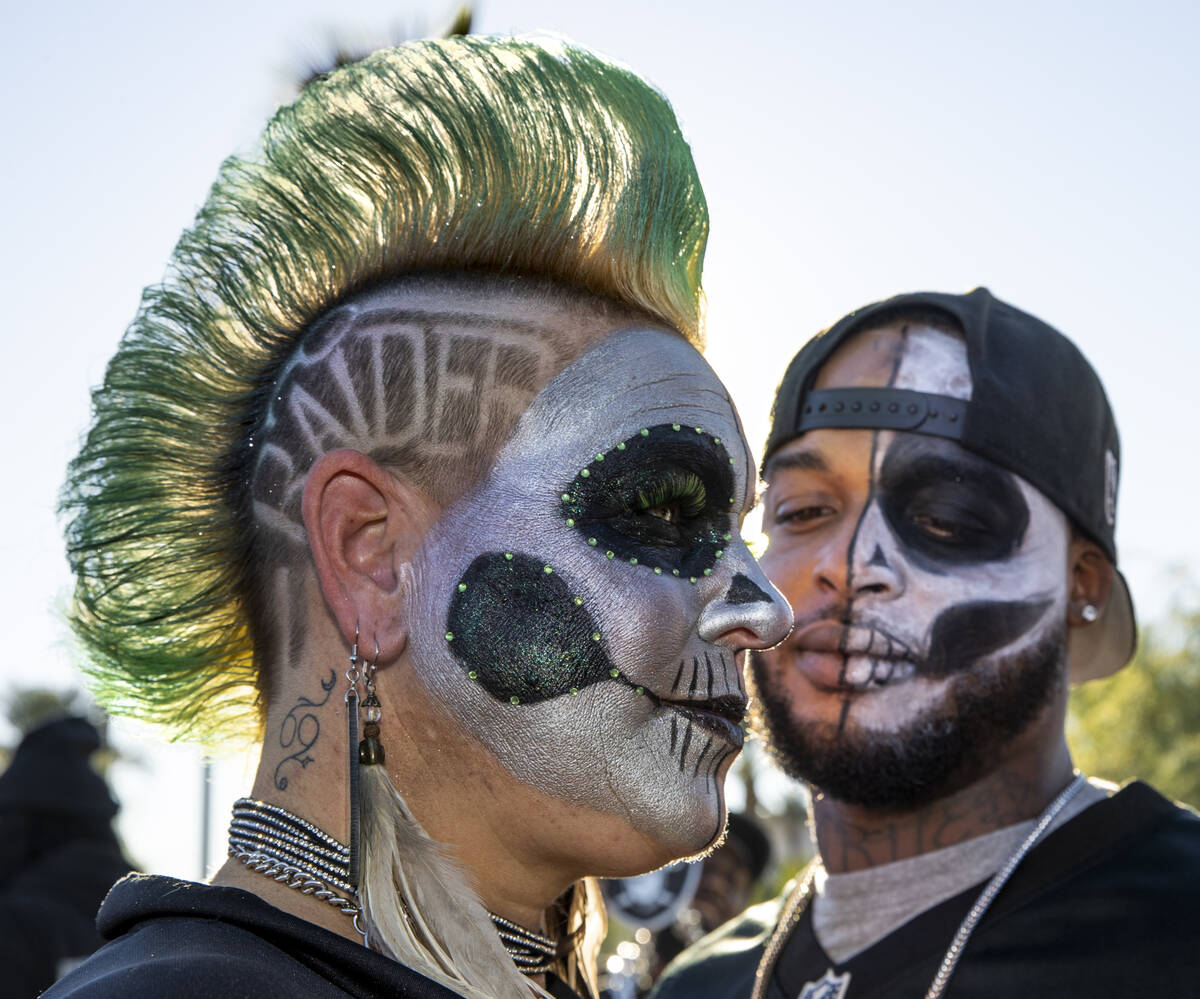 Raiders fans Jersey Tucker, left, and Jamal Jones gather with friends in tailgating before an N ...