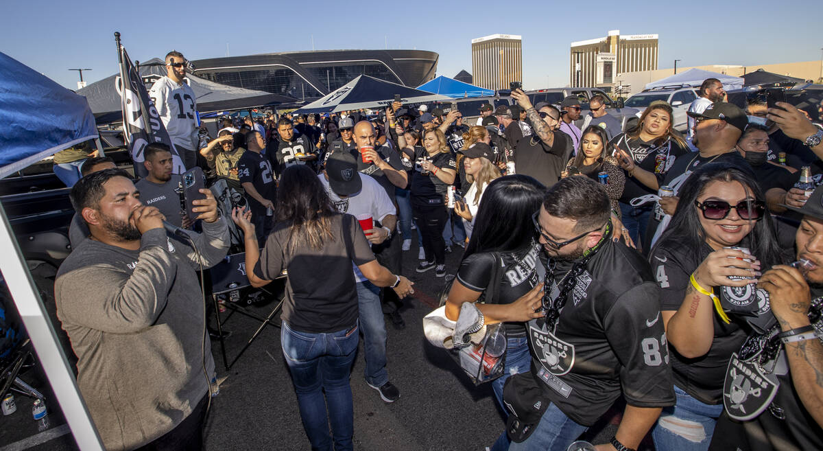 Raiders fans dance to live Mexican music in tailgating before an NFL game versus the Kansas Cit ...