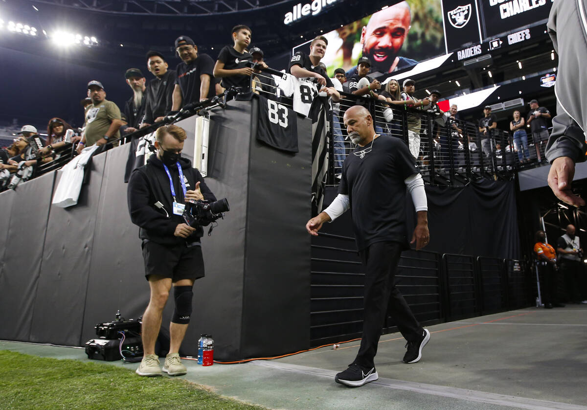 Raiders interim head coach Rich Bisaccia walks onto the field before the start of an NFL game a ...