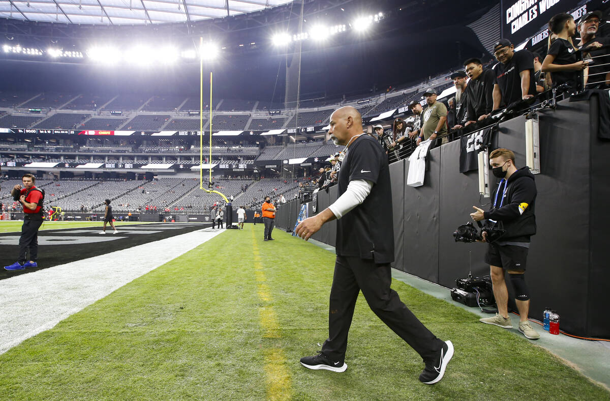 Raiders interim head coach Rich Bisaccia walks onto the field before the start of an NFL game a ...