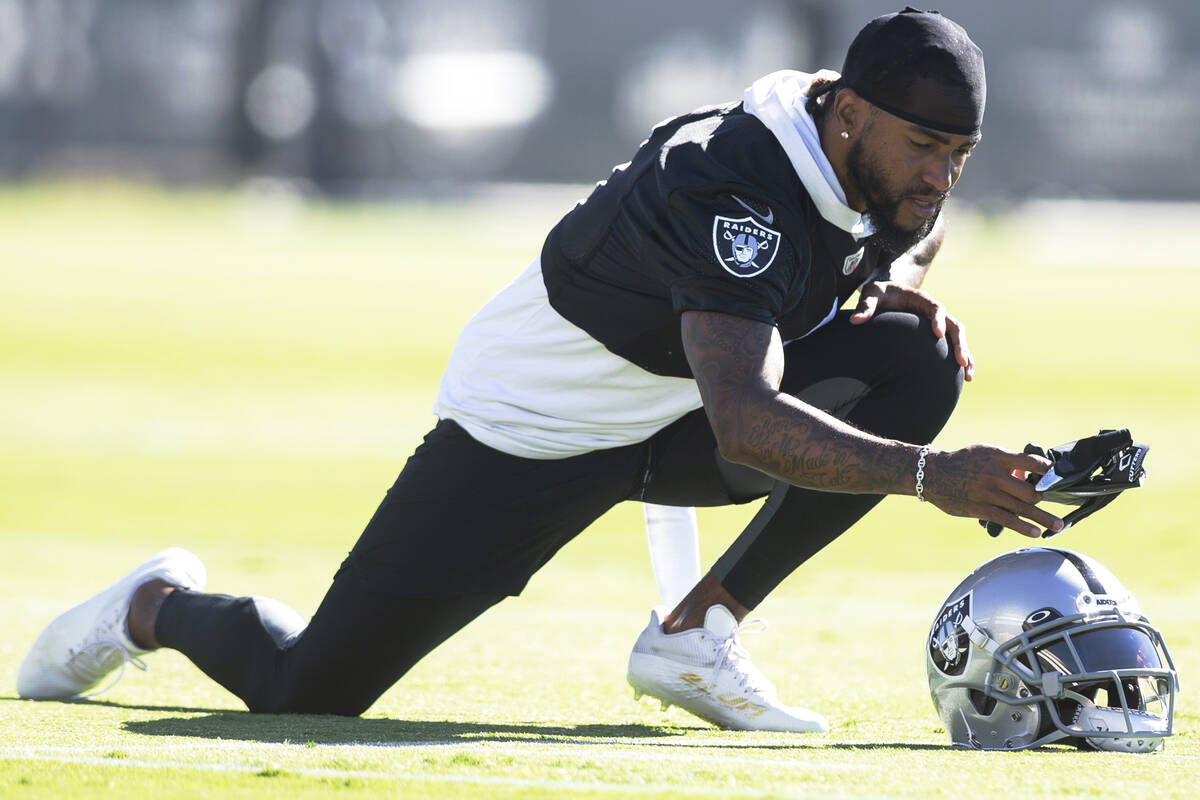 Raiders wide receiver DeSean Jackson (1) grabs a pair of gloves while stretching during a pract ...