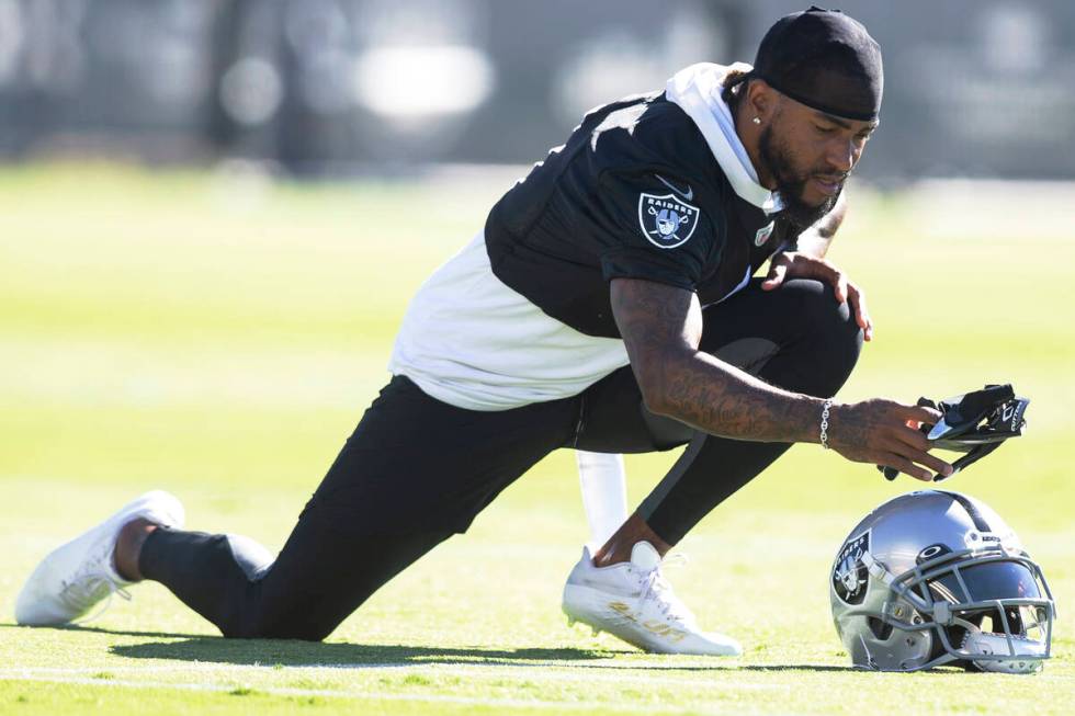 Raiders wide receiver DeSean Jackson (1) grabs a pair of gloves while stretching during a pract ...