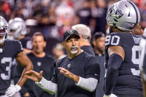 Raiders interim head coach Rich Bisaccia talks with Raiders defensive tackle Johnathan Hankins ...
