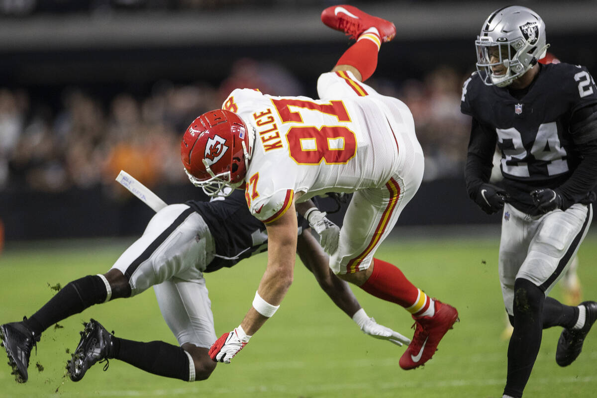 Kansas City Chiefs tight end Travis Kelce (87) is tackled by Raiders safety Johnathan Abram (24 ...