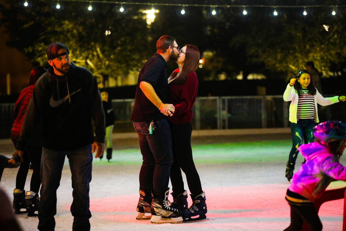 Austin Jacobson kisses his girlfriend Cadence Kapeles as they ice skate at the Rock Rink in Dow ...