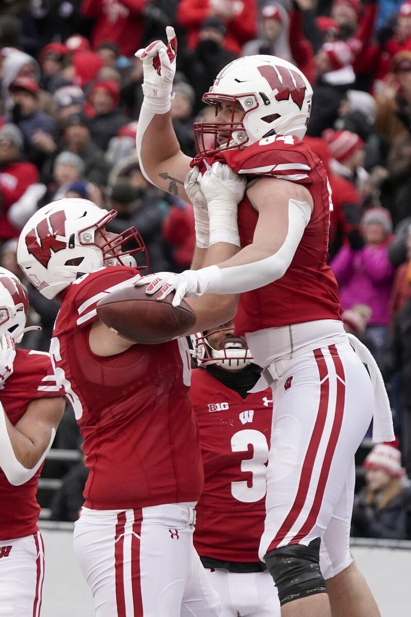 Wisconsin's Jake Ferguson is lifted by Tyler Beach after catching a touchdown pass during the s ...