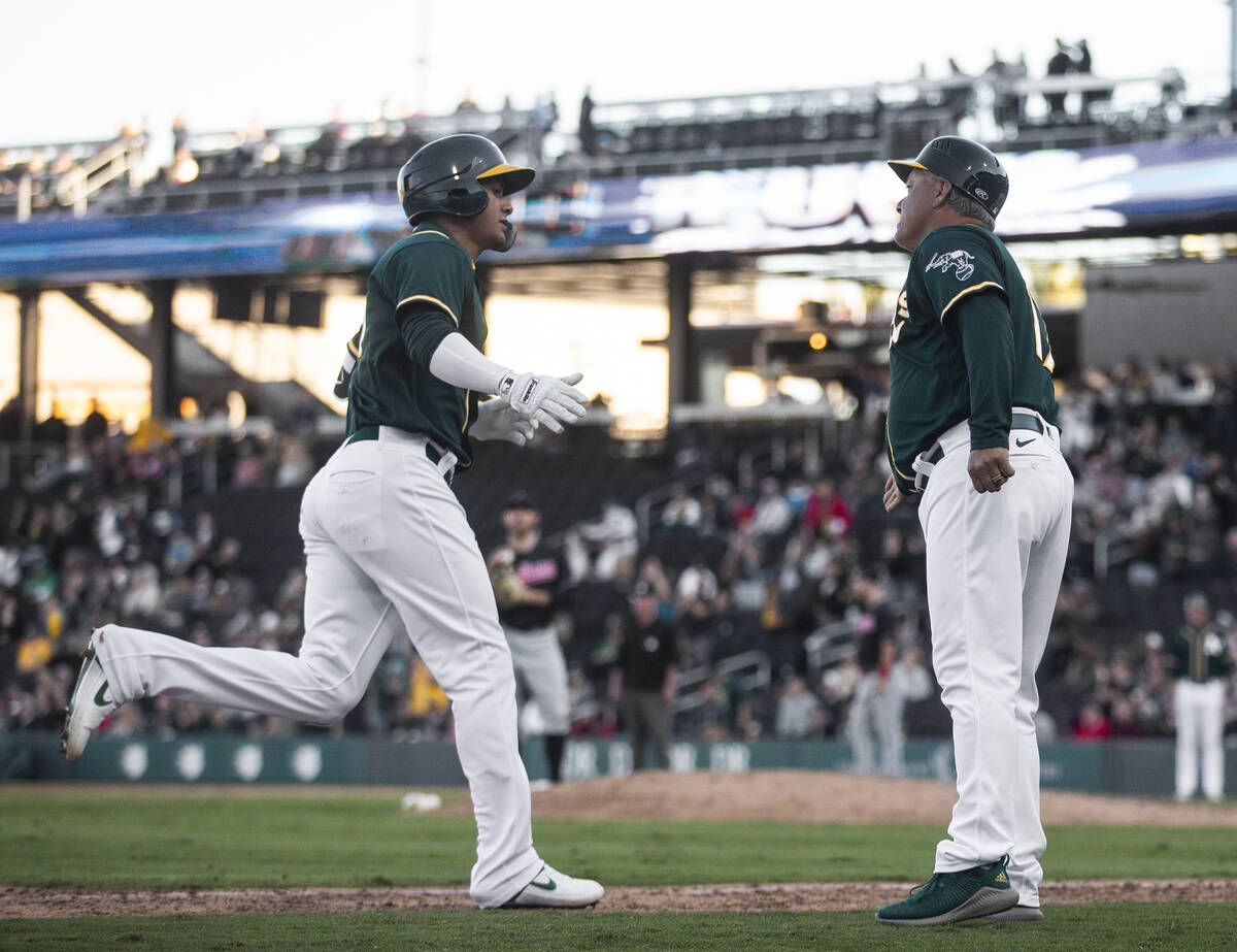 Oakland Athletics Edwin Diaz, left, rounds third base after hitting a home run in the 8th innin ...