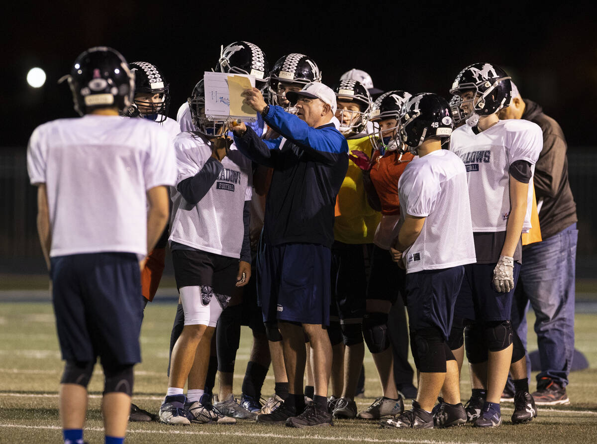 The Meadows High School defensive coordinator Rodney Vollan discusses the game plan with his pl ...