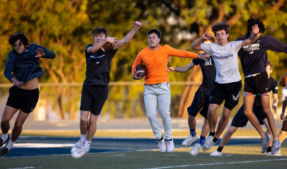 The Meadows High School football players, including Ben Vinocur, center, warm up during practic ...