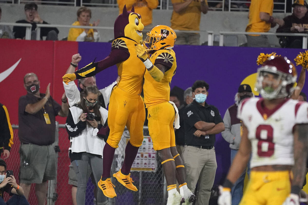Arizona State running back Rachaad White (3) chest bumps Sun Devil mascot Sparky after scoring ...