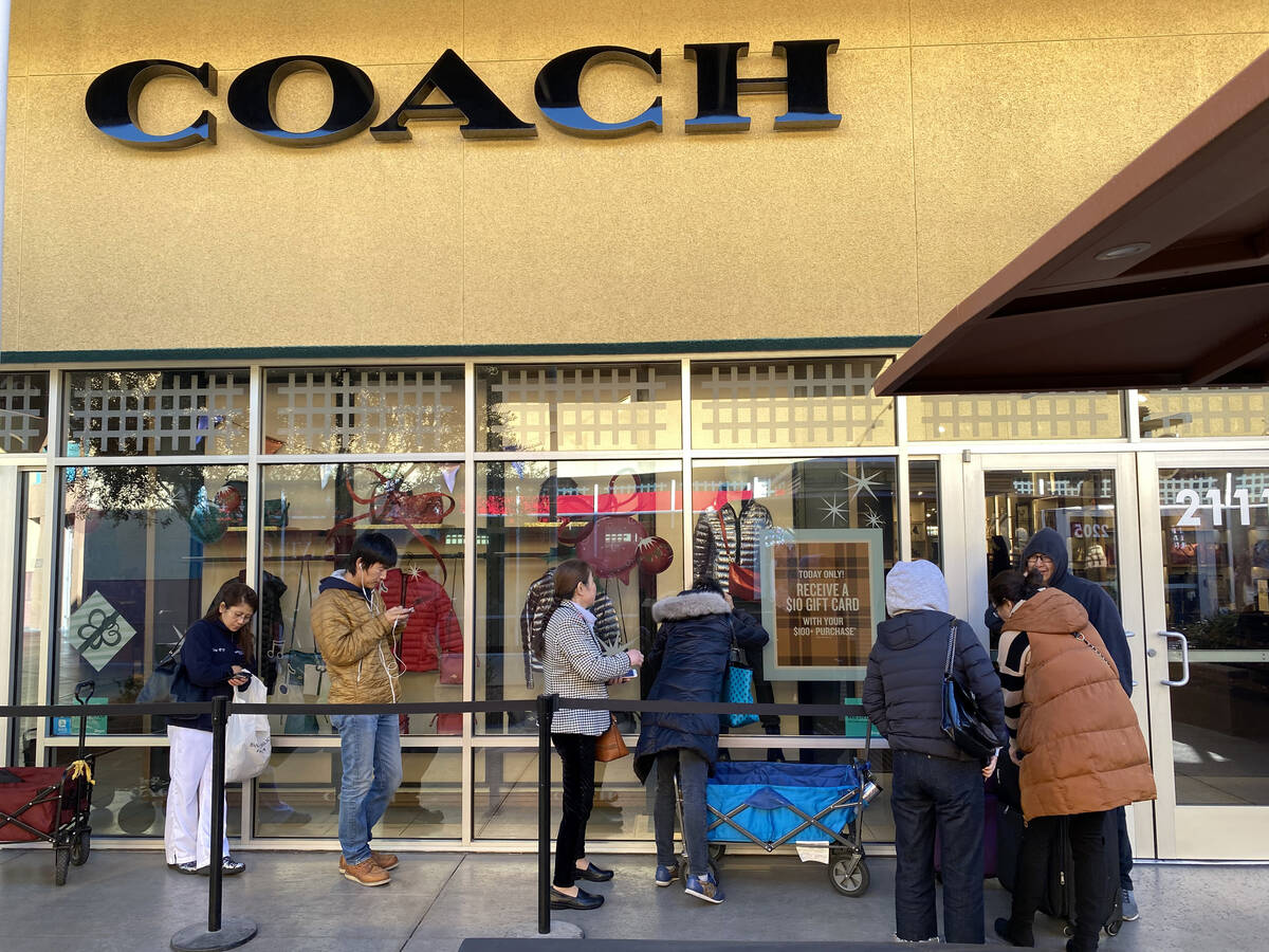People line up at the Coach store at Las Vegas North Premium Outlets before opening on Thanksgi ...