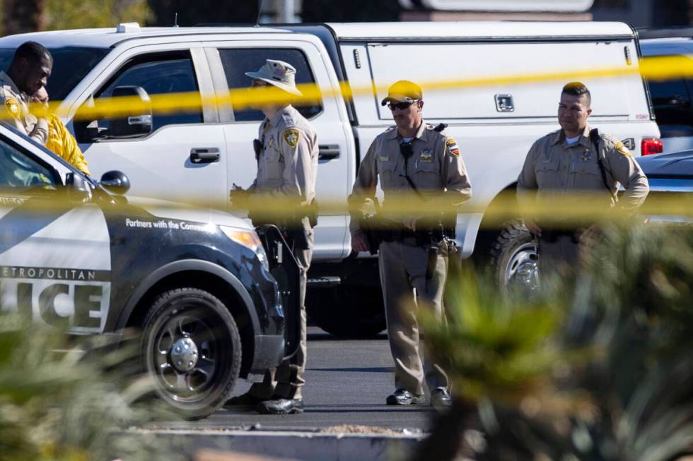 Las Vegas police officers investigate an officer-involved shooting at 3200 Tenaya Way, on Wedne ...