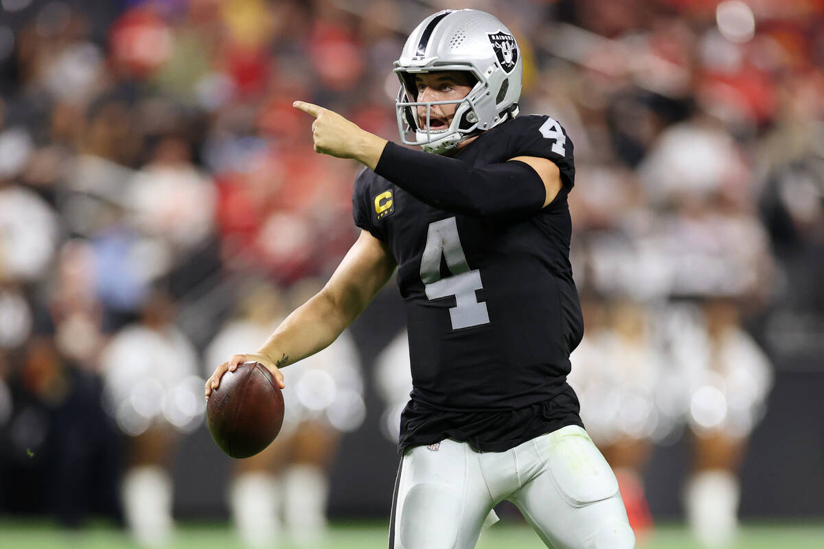 Raiders quarterback Derek Carr (4) gestures to his team during a fourth down play in the second ...