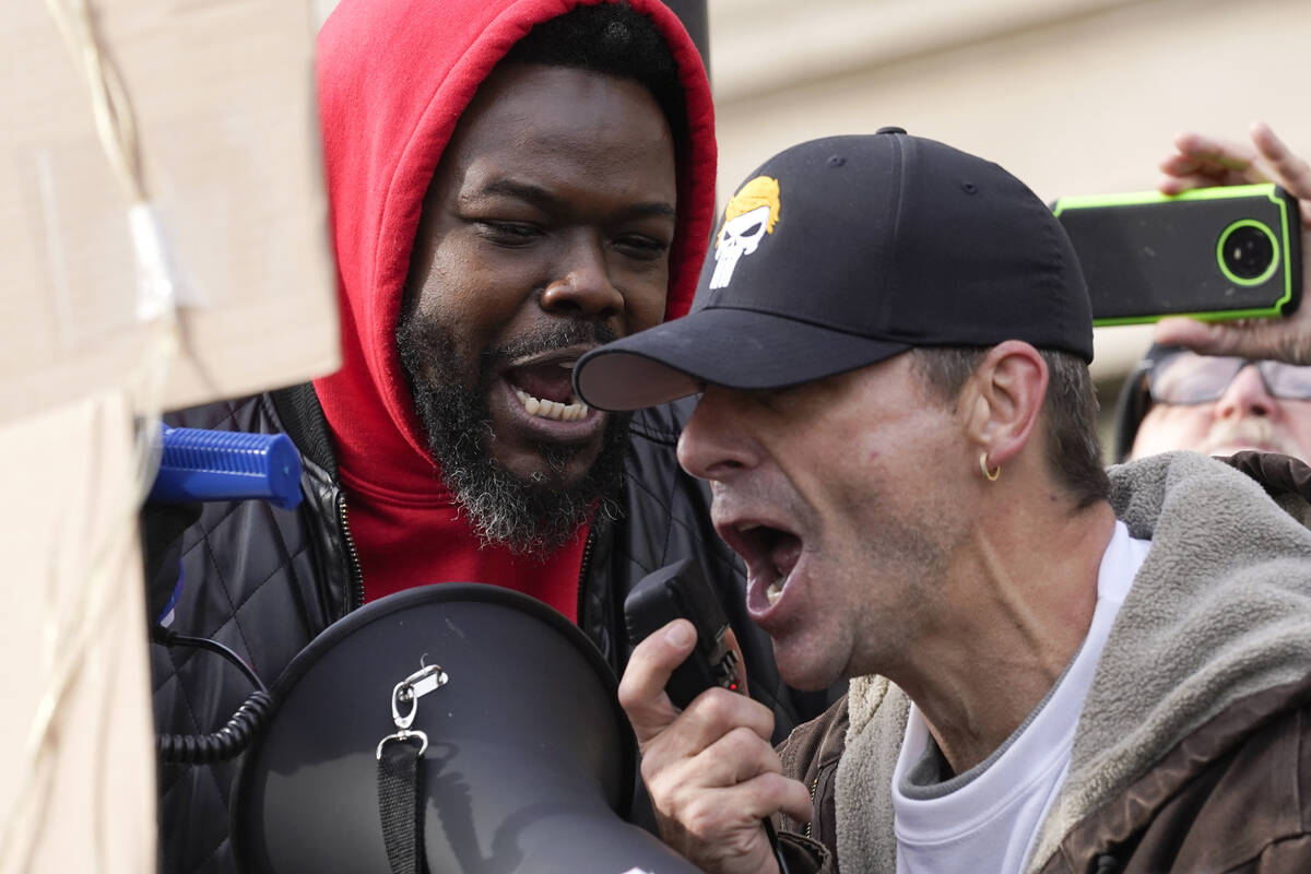 Protesters confront each other outside the Kenosha County Courthouse, Tuesday, Nov. 16, 2021, i ...