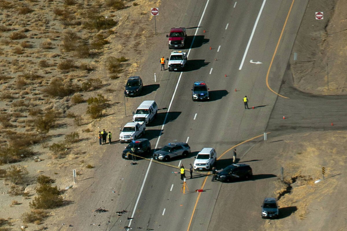 The Nevada Highway Patrol works the scene of a fatal crash involving multiple bicyclists and a ...