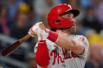 Philadelphia Phillies' Bryce Harper watches his two-run home run during the third inning of the ...