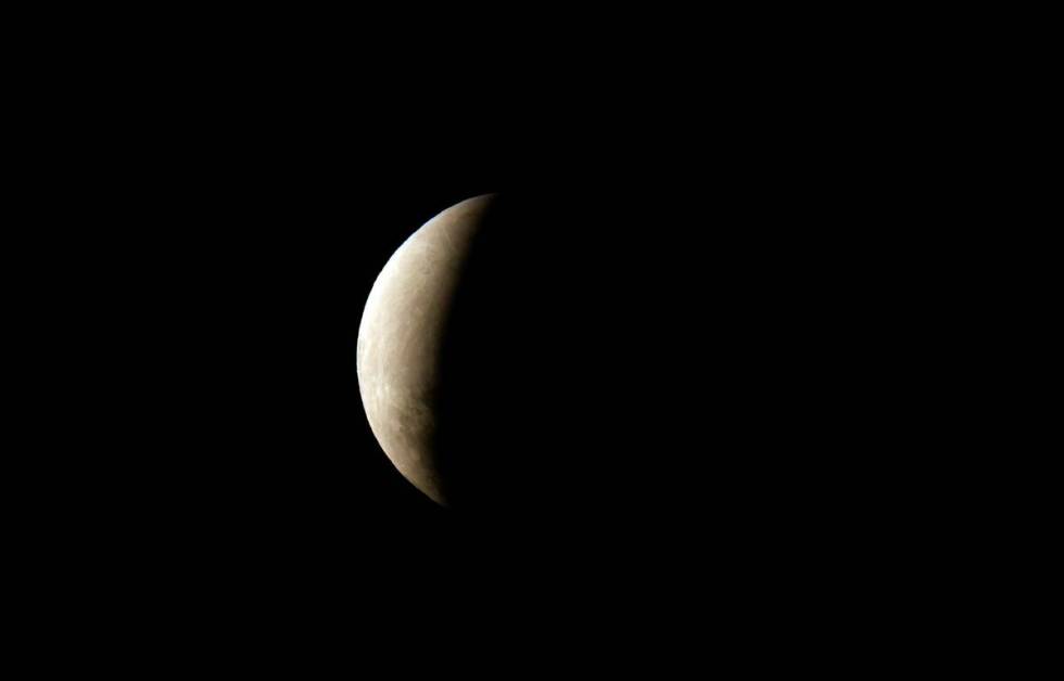 A partially eclipsed moon is seen from Asuncion, Paraguay, early Friday, Nov. 19, 2021. (AP Pho ...