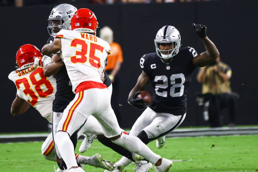 Raiders running back Josh Jacobs (28) runs the ball against the Kansas City Chiefs during the f ...