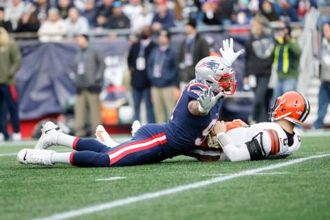 Cleveland Browns quarterback Baker Mayfield (6) is sacked by New England Patriots defensive end ...