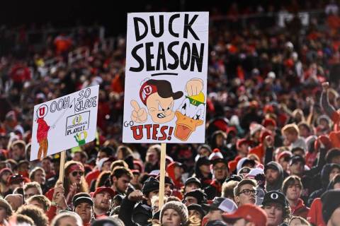 Utah fans hold signs during the second half of an NCAA college football game against Oregon Sat ...