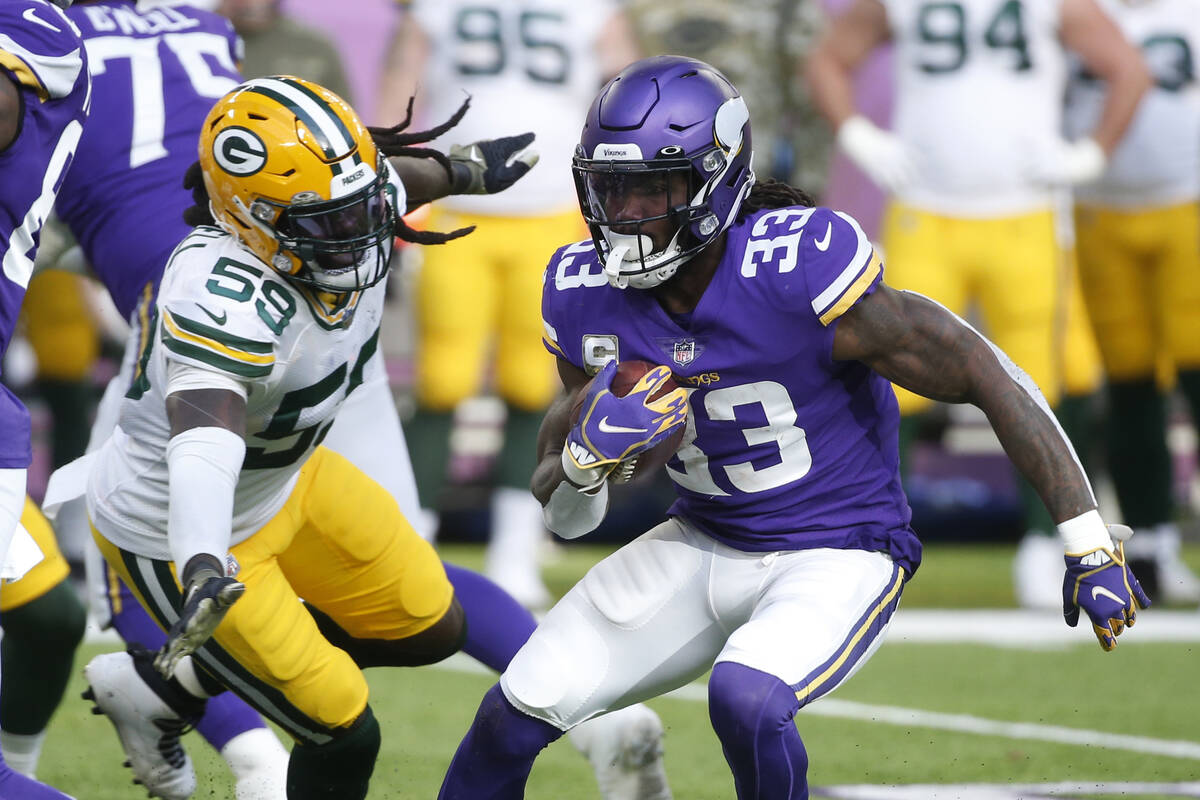 Minnesota Vikings running back Dalvin Cook (33) runs from Green Bay Packers inside linebacker D ...