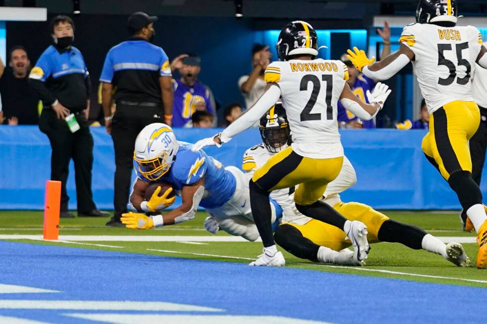 Los Angeles Chargers running back Austin Ekeler scores a touchdown during the second half of an ...
