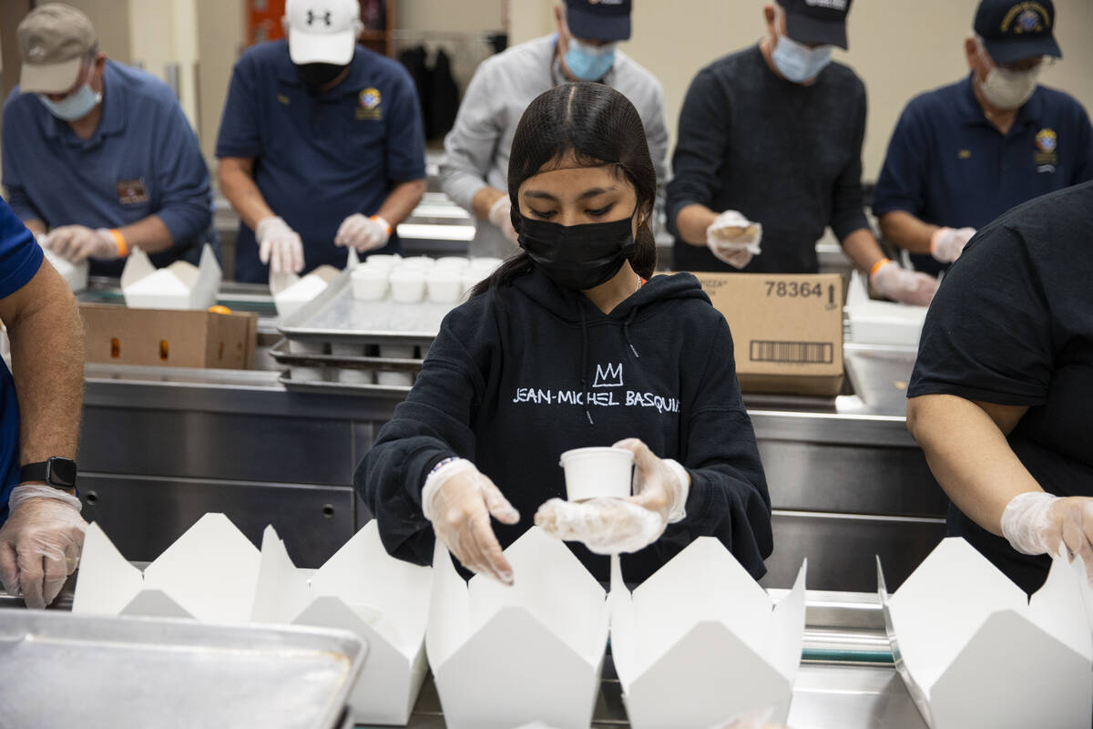 Volunteer Darline Bie puts together after school lunches at the Three Square North Campus in La ...