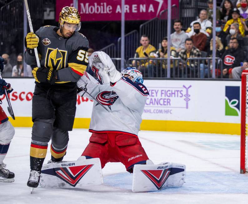 Golden Knights right wing Keegan Kolesar (55) tangles with Columbus Blue Jackets goaltender Elv ...