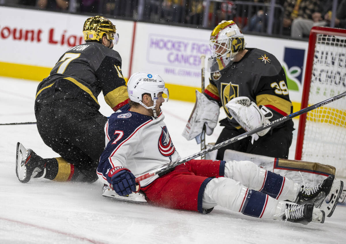 Golden Knights defenseman Alex Pietrangelo (7) gets tangled up with Columbus Blue Jackets cente ...