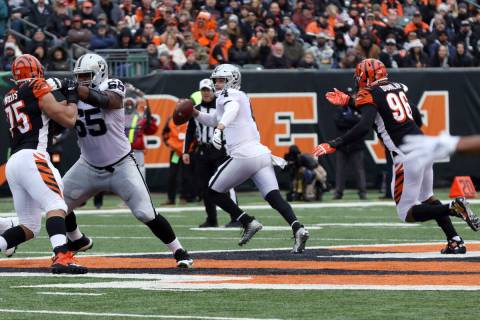 Oakland Raiders quarterback Derek Carr (4) scrambles with the football as Cincinnati Bengals de ...