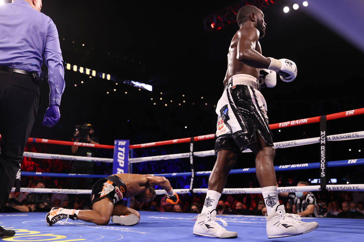 Shawn Porter, left, is knocked down by Terence Crawford in the 10th round of the WBO welterweig ...