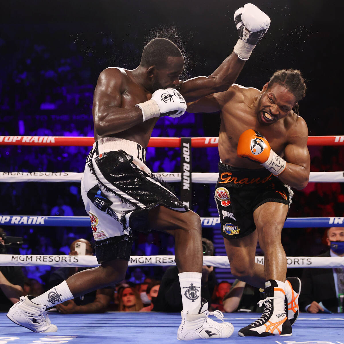 Terence Crawford, left, battles Shawn Porter in the eight round of a WBO welterweight title fig ...