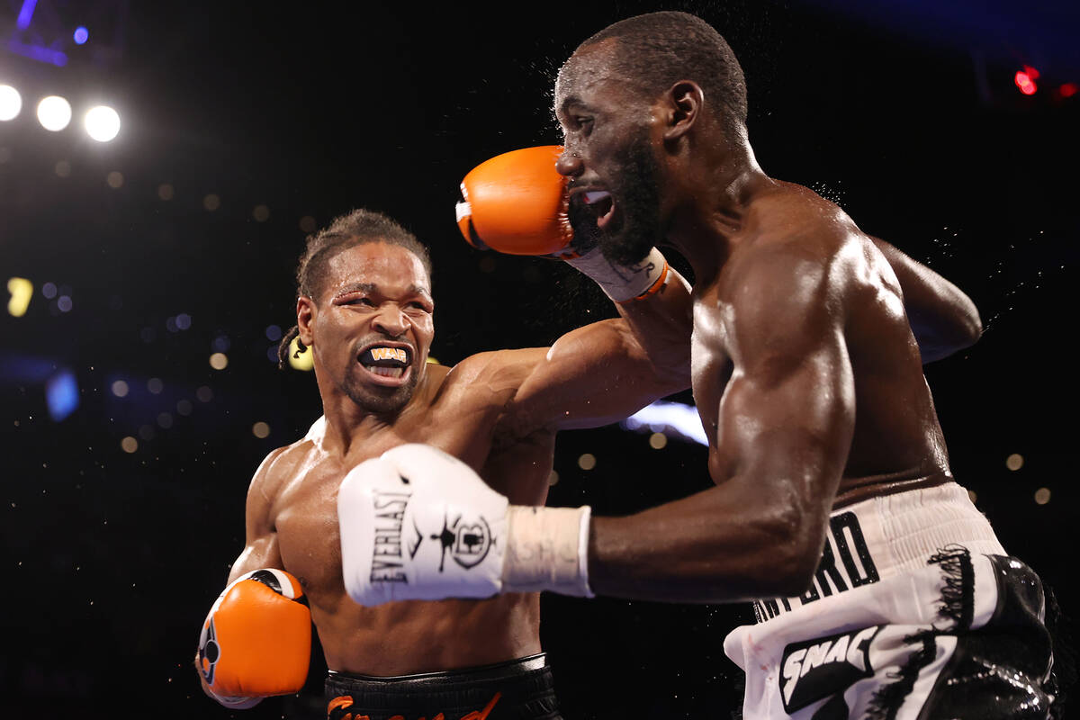 Shawn Porter, left, connects a punch against Terence Crawford in the seventh round of a WBO wel ...