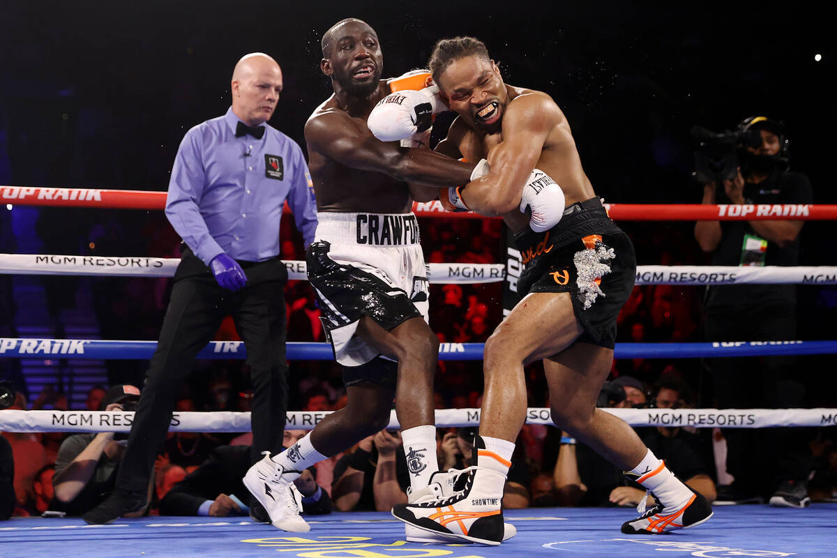 Terence Crawford, left, battles Shawn Porter in the third round of a WBO welterweight title fig ...