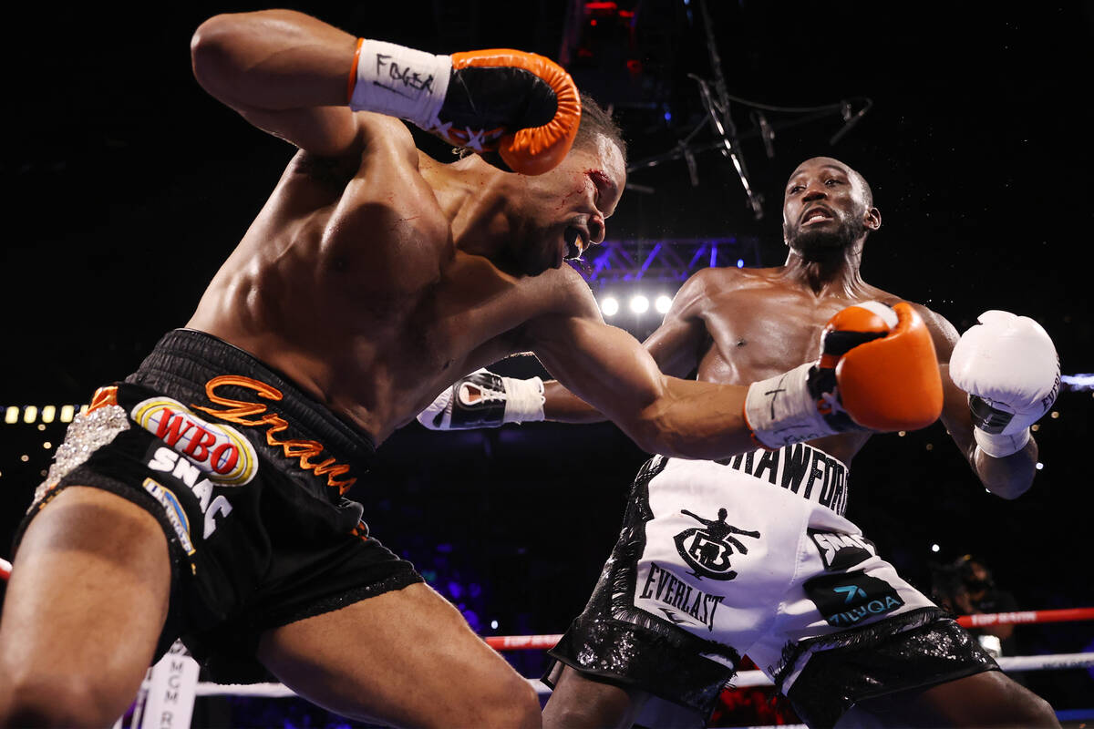 Shawn Porter, left, battles Terence Crawford in the third round of a WBO welterweight title fig ...
