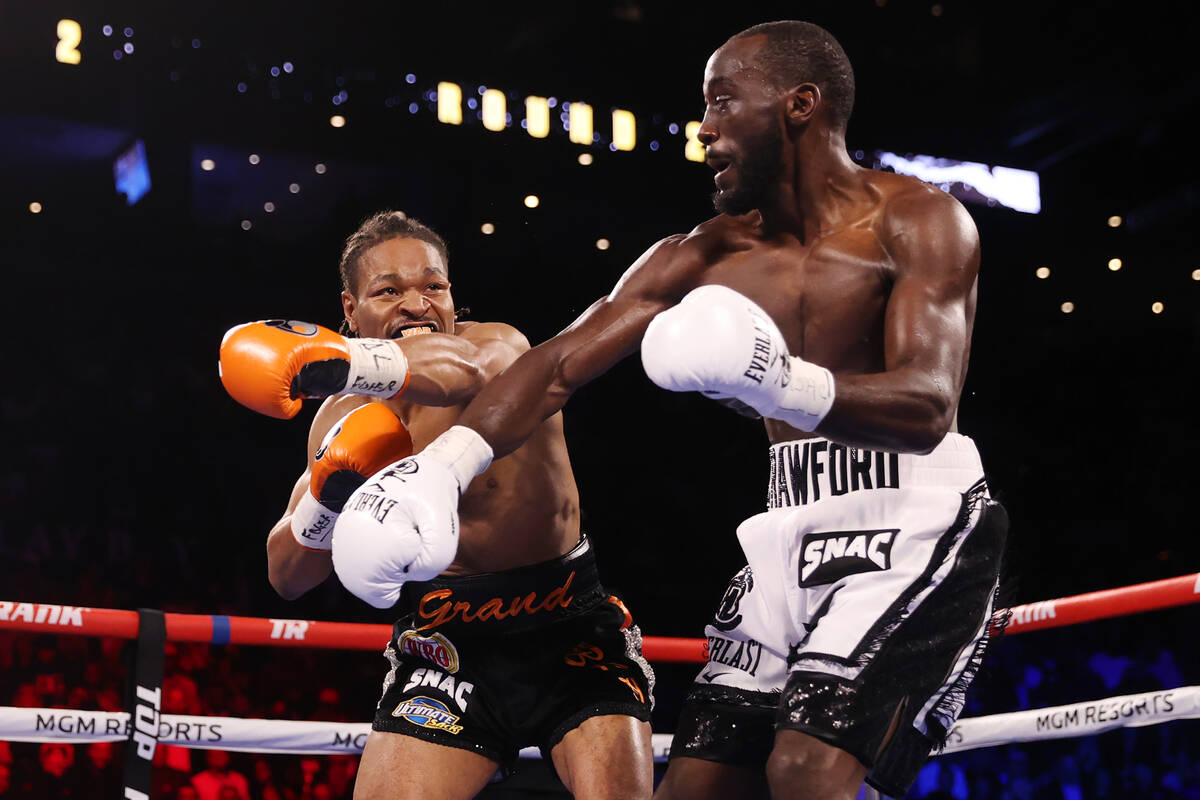 Shawn Porter, left, battles Terence Crawford in the second round of a WBO welterweight title fi ...