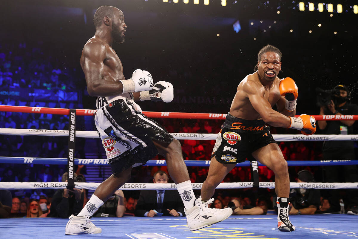 Terence Crawford, left, battles Shawn Porter in the eight round of a WBO welterweight title fig ...
